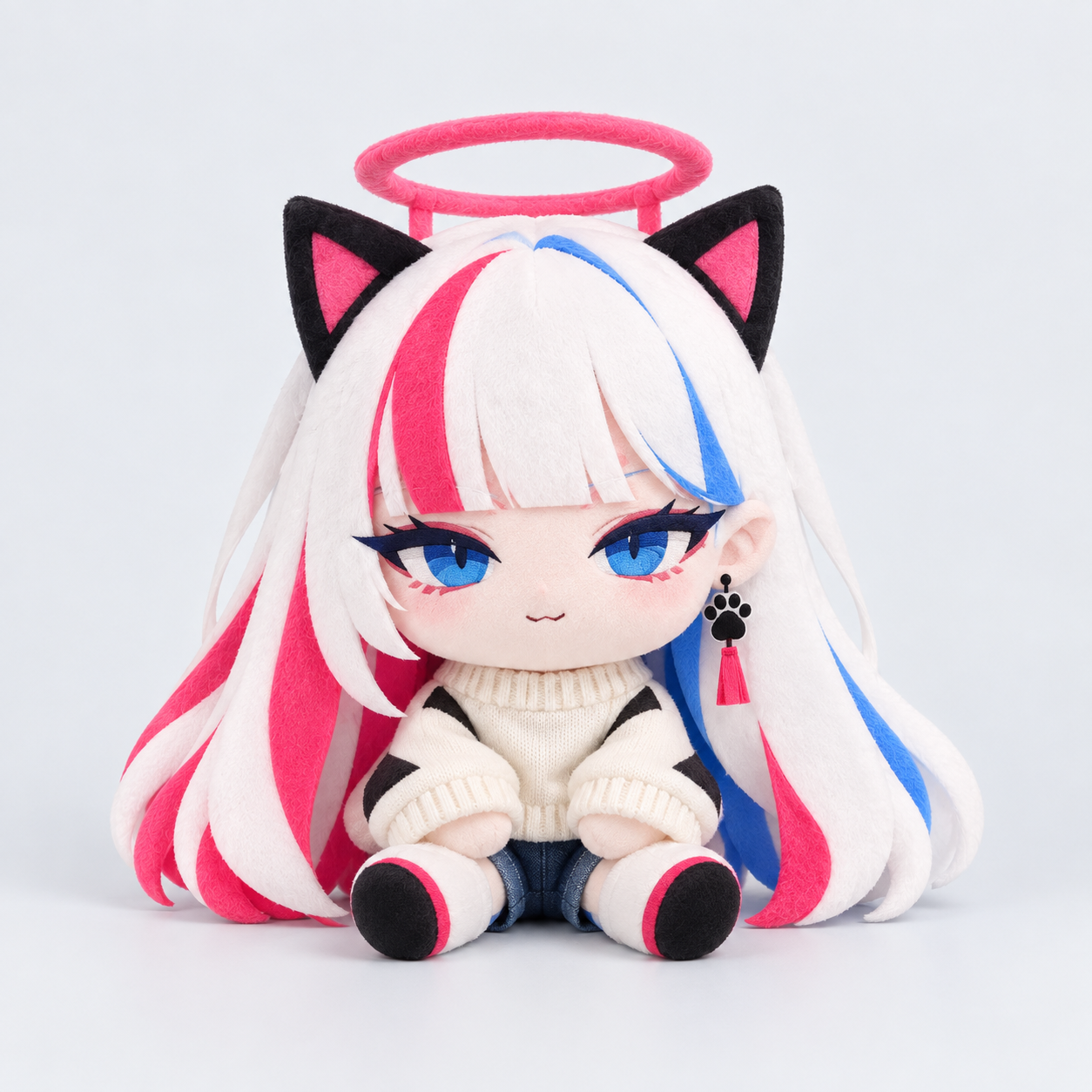 Small two-head-tall MUA plush with simplified blue embroidered eyes, an ivory sweater and blue shorts.